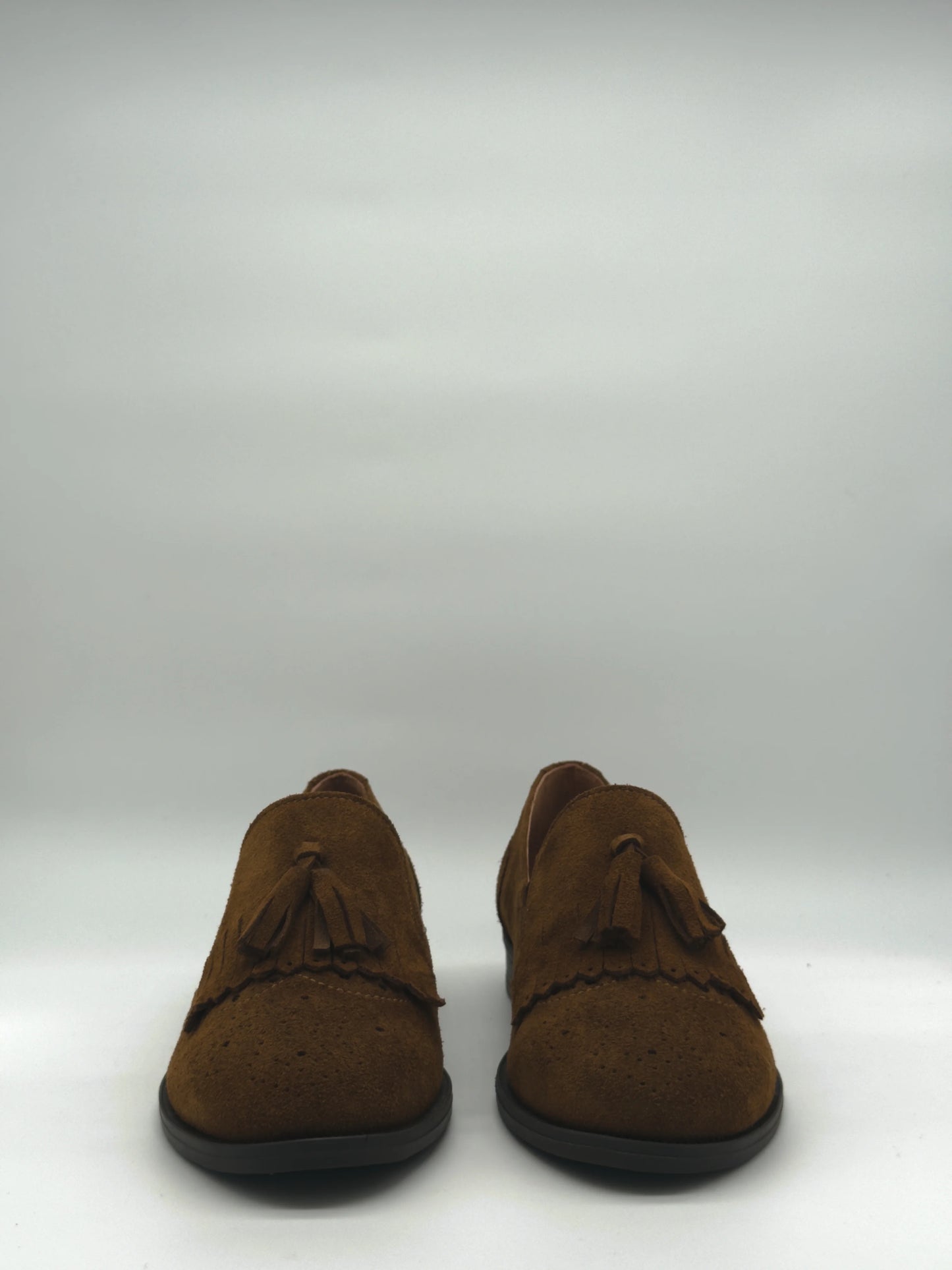 Mocasines clásicos con flecos y borla en color camel y taupe.