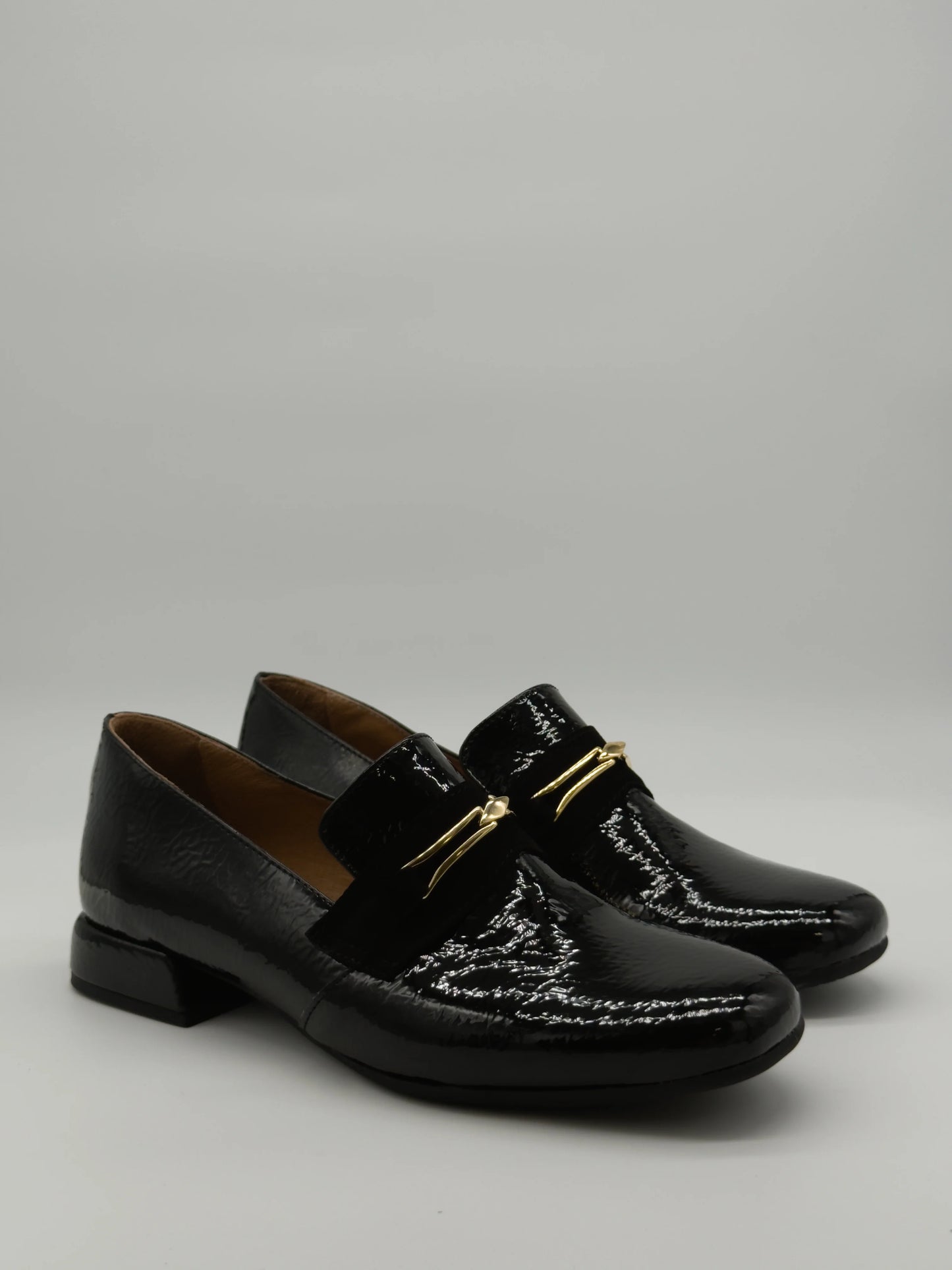 Mocasines negros clásicos para mujer con detalle dorado